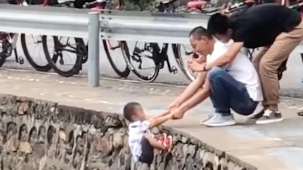 Verstörender Grund: Mann hält Kleinkind über Abgrund